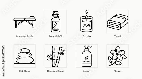 Relaxing spa essentials: massage table, oils, candles, towels, stones, bamboo, lotion, flowers.