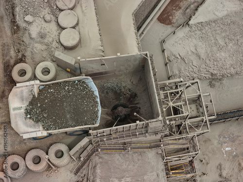 Obraz na płótnie Aerial view of material unloading at primary crusher with CAEX mining dump truck