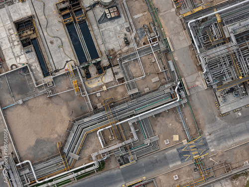 Aerial view of an oil refinery alongside multi-level stainless steel piping systems