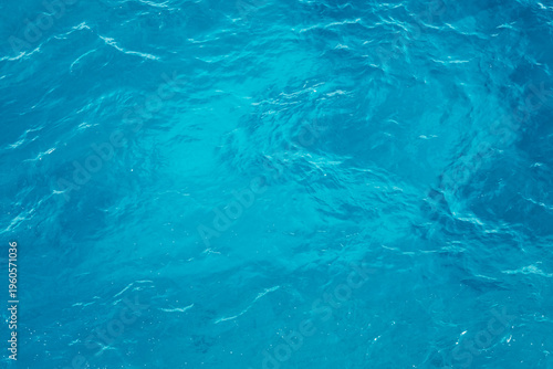 Waves move over the deep blue ocean creating a unique water pattern