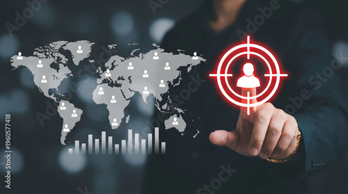 Business professional finger points to target icon on global customer network map with data chart