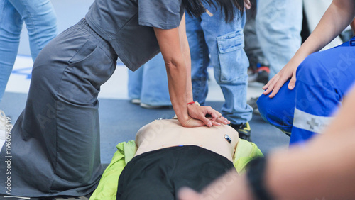 Bild auf Leinwand Person performing CPR chest compressions on mannequin during first aid training
