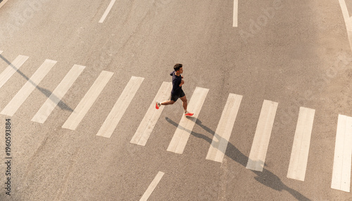 Athlete run over crosswalk top view Healthy lifestyle Urban exercise
