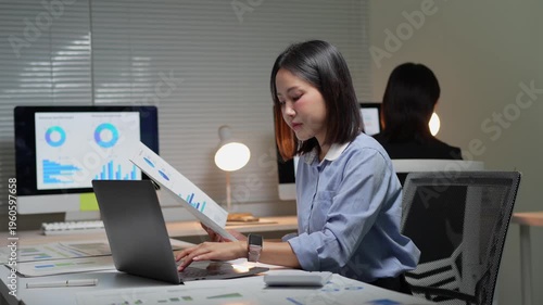Businesswoman analyzing financial data and working overtime at night