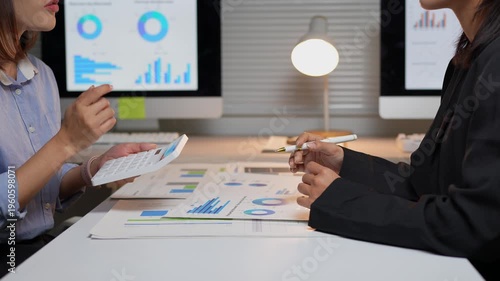 Financial analysts collaborating on company data report