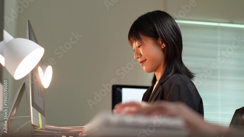 Young asian businesswoman working late on computer in the office