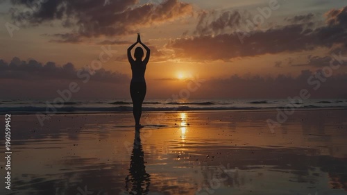 silhouette of a woman doing a yoga pose (possibly a variation of Tree Pose or Tadasana with hands up) on the beach at sunset.