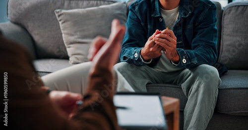 Fotografia Hands, anxiety and man on sofa by therapist for emotional support, help or advice on mental health