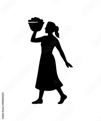 Female farm worker harvesting grapes carrying a full basket