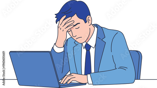 Tired businessman working late on laptop with head in hand.