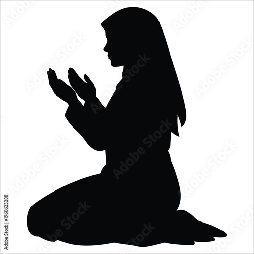 A woman in prayer on her knees in black silhouette