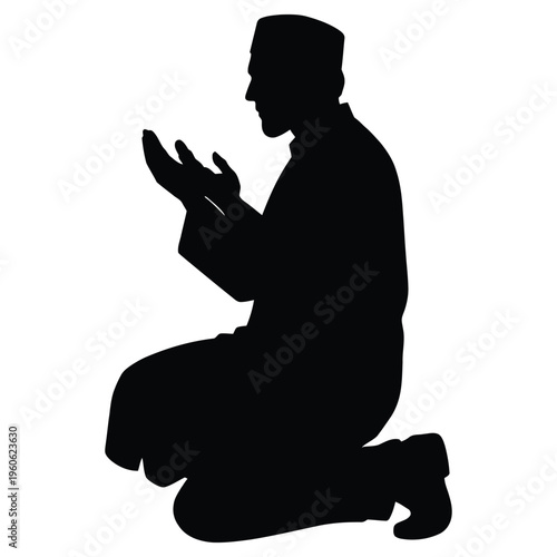 A man in a silhouette praying on his knees