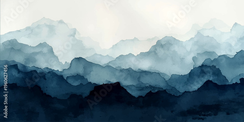 A misty mountain landscape of high Alps peaks and deep valleys shrouded in fog and snow under a blue morning sky with clouds at sunrise