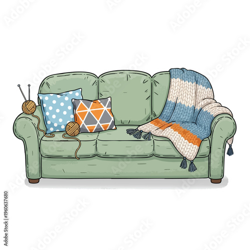Cozy green sofa with pillows, yarn, knitting needles, and striped blanket