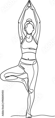 A woman is standing on one leg in a yoga pose