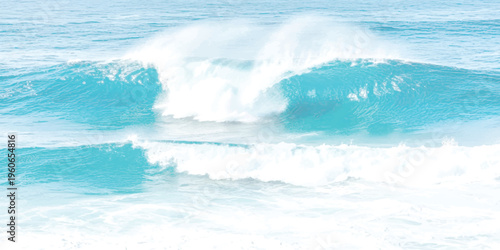 A powerful turquoise ocean wave crashing with white sea spray against the vast tropical horizon