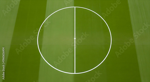 Pristine green sports field with clearly marked white lines, highlighting the central circle and midfield demarcation, ready for competitive play and athletic events