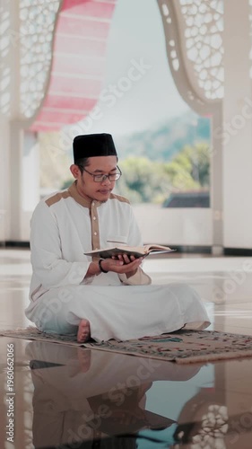 A Muslim man performing Islamic pray inside a mosque during Ramadan, a peaceful spiritual moment with beautiful mosque architecture.