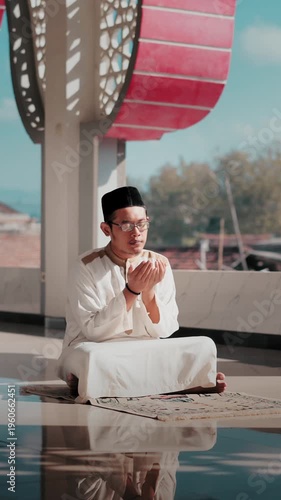 A Muslim man performing Islamic pray inside a mosque during Ramadan, a peaceful spiritual moment with beautiful mosque architecture.