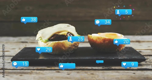 Vertical video: Dripping sauce from top, two buns on slate attracting blue icons with rising counts