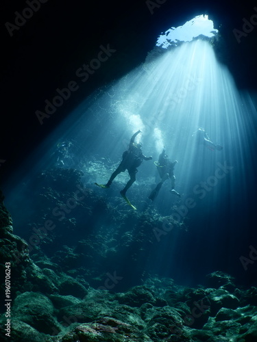 sun rays sun beams and sun shine underwater in cave beautiful light scenery in ocean scuba divers to see in cave backgrounds