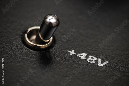 Macro shot with selective focus of phantom power switch on audio interface
