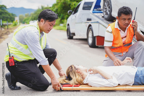 Ambulance and rescue paramedic helping woman driver from car accident on road
