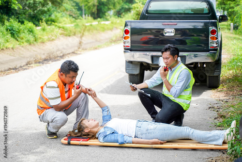 Ambulance and rescue paramedic helping woman driver from car accident on road