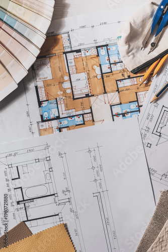 architect Eco retrofit planning with blueprints, material swatches and finish samples, sustainable renovation budget and healthy material selection concept for honest architectural design.