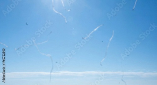 Visual simulation of eye floaters against bright blue sky