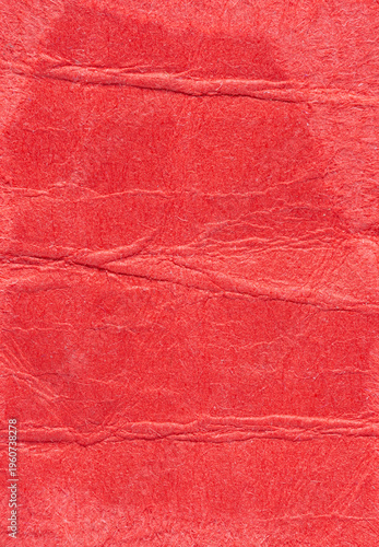 Red crumpled wrinkled paper background or backdrop with fine details and texture with copy space for text design element