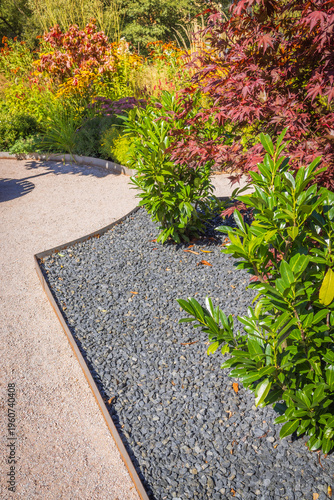 Garden path with  gravel, weeds blocking