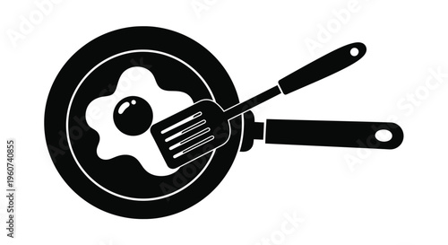 Black silhouette of a frying pan with an egg and spatula
