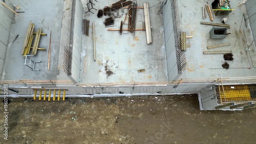 Reinforced concrete structures, see reinforcement, steel bars ready for pouring wall or column. System formwork: Yellow panels and metal frames are used to form concrete into desired shape. Fresh