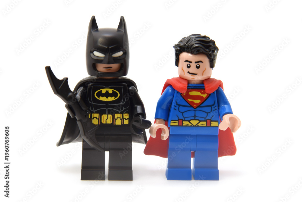 Obraz premium Lego minifigures of Superman in costume with red coat and batman in black coat with bat. Editorial illustrative image of popular children toys and comic heroes.