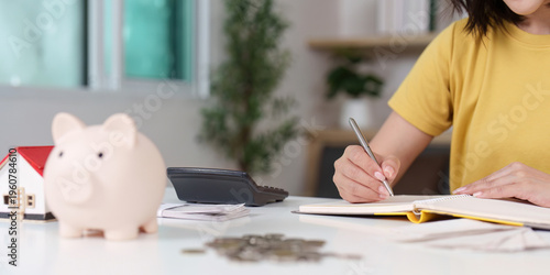 Close-up of financial planning with piggy bank and notebook