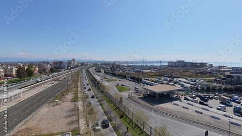 Elevated view of intense road traffic near the port of Durres, Albania. Urban infrastructure, busy transportation hub, cars and trucks moving along coastal roads, logistics and trade activity