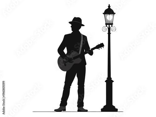 Silhouette of musician playing guitar near a vintage street lamp at night
