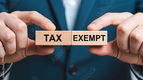 Business professional holding TAX EXEMPT sign for financial savings and benefits