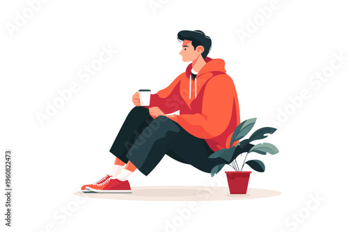 Young caucasian male sitting with coffee and plant in casual attire