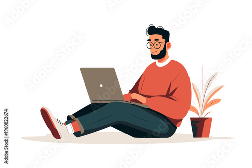 Young hispanic male using laptop while sitting on floor with potted plant