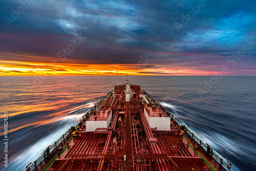 Billede på lærred High angle view of a large oil tanker vessel deck with red pipes sailing in the
