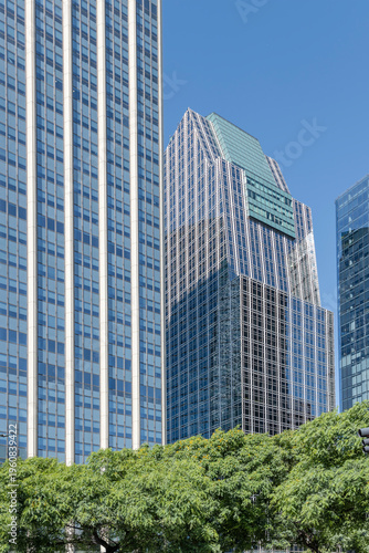 glass facades of modern skyscrapers looms over trees on  avenida Leandro N. Alem, Buenos Aires, Argentina