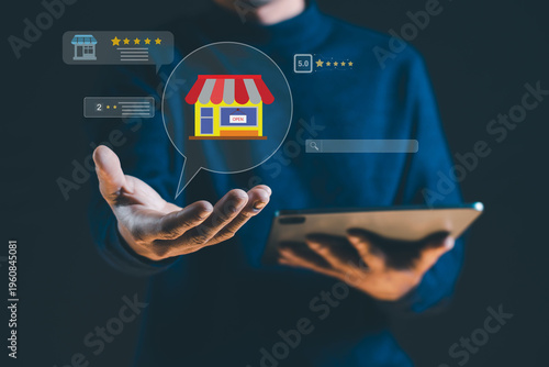A modern digital marketing concept showing a person holding a tablet with a virtual interface featuring a local shop icon, customer reviews, and star ratings.