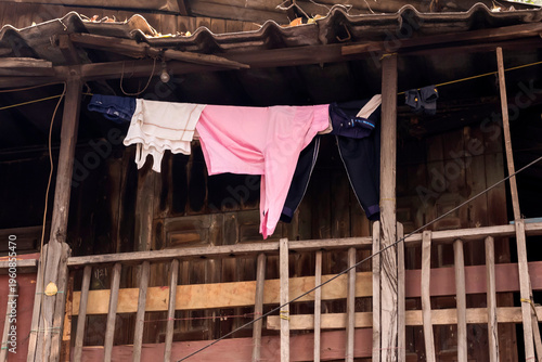 Photography Shirt hanging in a wooden old wooden house balcony