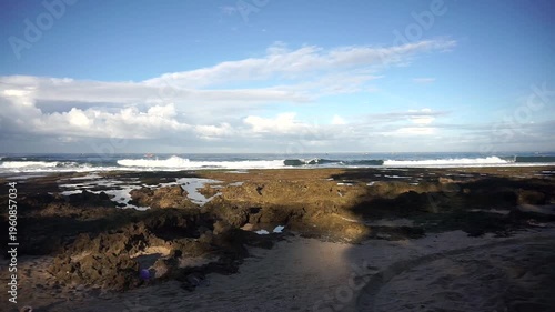 Wallpaper Mural Coastal view with rocky shore and ocean waves under a bright blue sky, showcasing natural seaside beauty. Torontodigital.ca