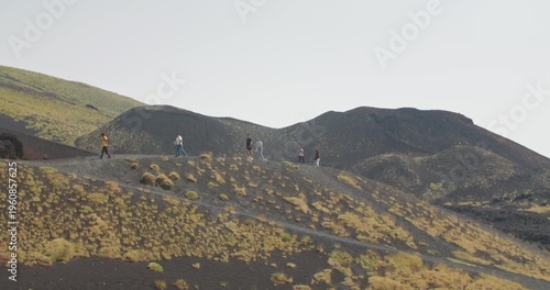 Etna Volcano hiking trip, people walking on dark hills, Sicily, Italy, 4k