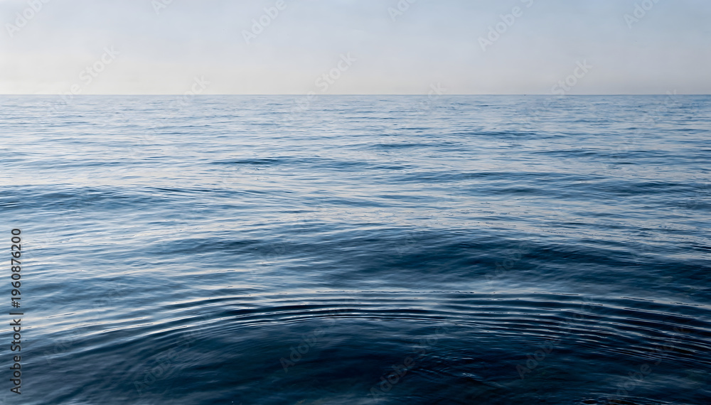 Fototapeta premium Calm Horizon: Expansive Blue Ocean Water Texture Under Clear Sky
