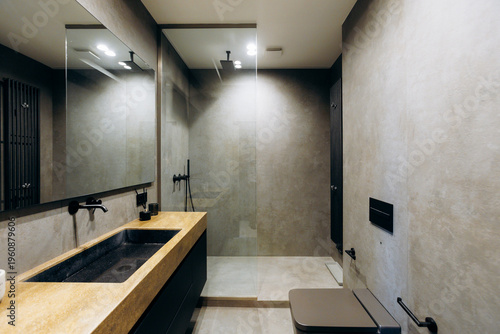 Minimalist bathroom featuring glass shower and matte black details
