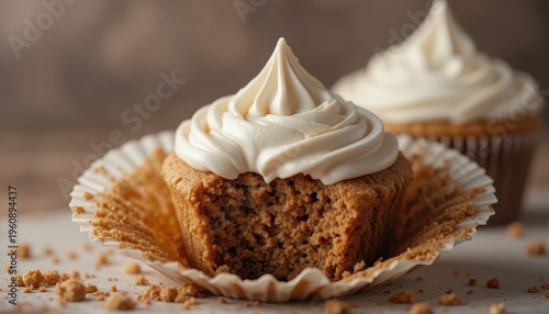 Delicious Vanilla Cupcake With Creamy Frosting Sitting On A Plate With Crumbs